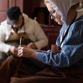 Shoemaking by costumed historians.