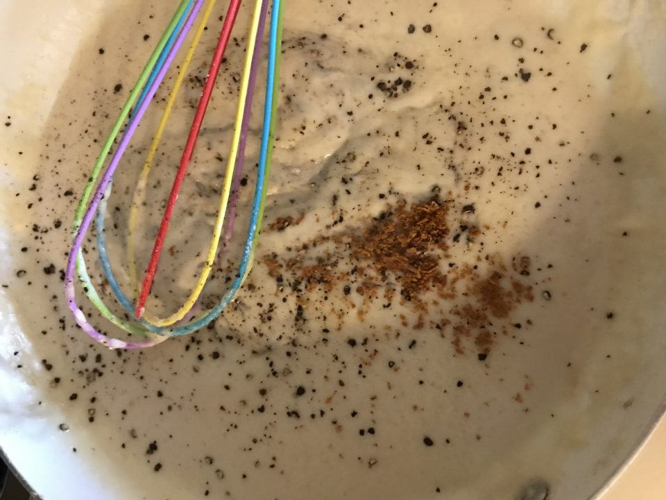 Adding mace, salt, and pepper