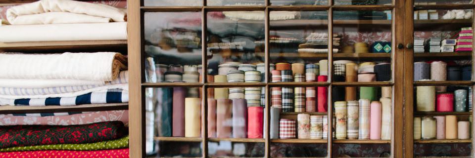 Fabric and trim on the shelves in the Asa Knight Store