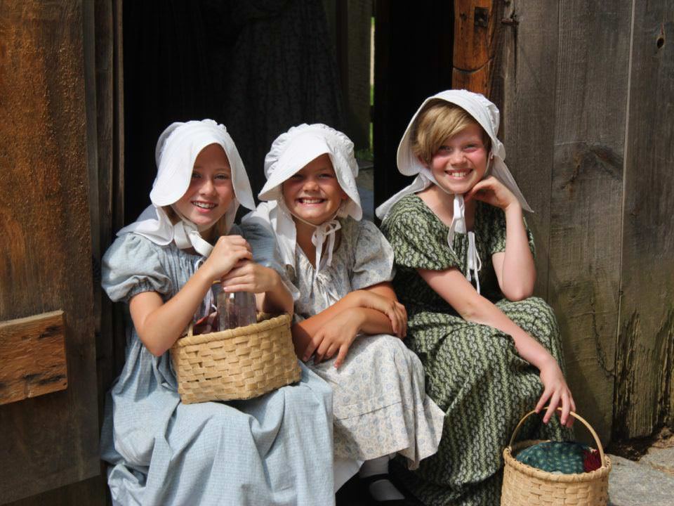 Three girls in costume smiling