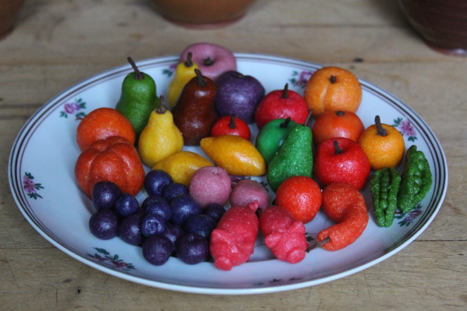 Marzipan shaped into fruits, vegetables, flowers, and pigs